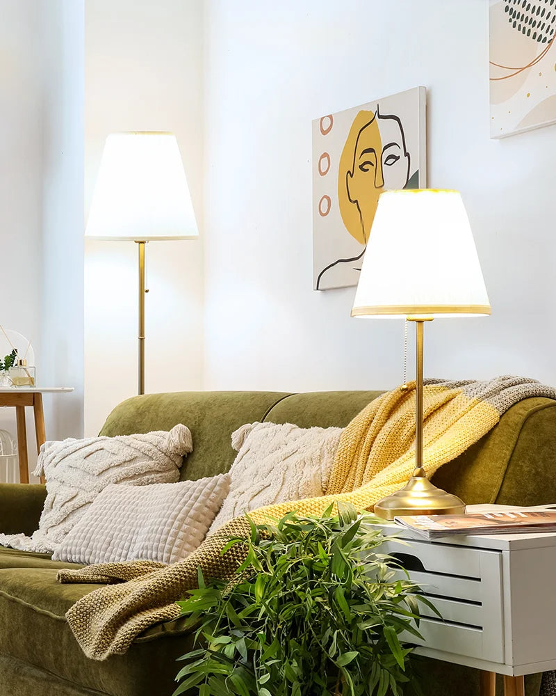 In-the-living-room-soft-and-warm-light-glows-from-the-table-lamp-and-floor-lamp-beside-the-sofa