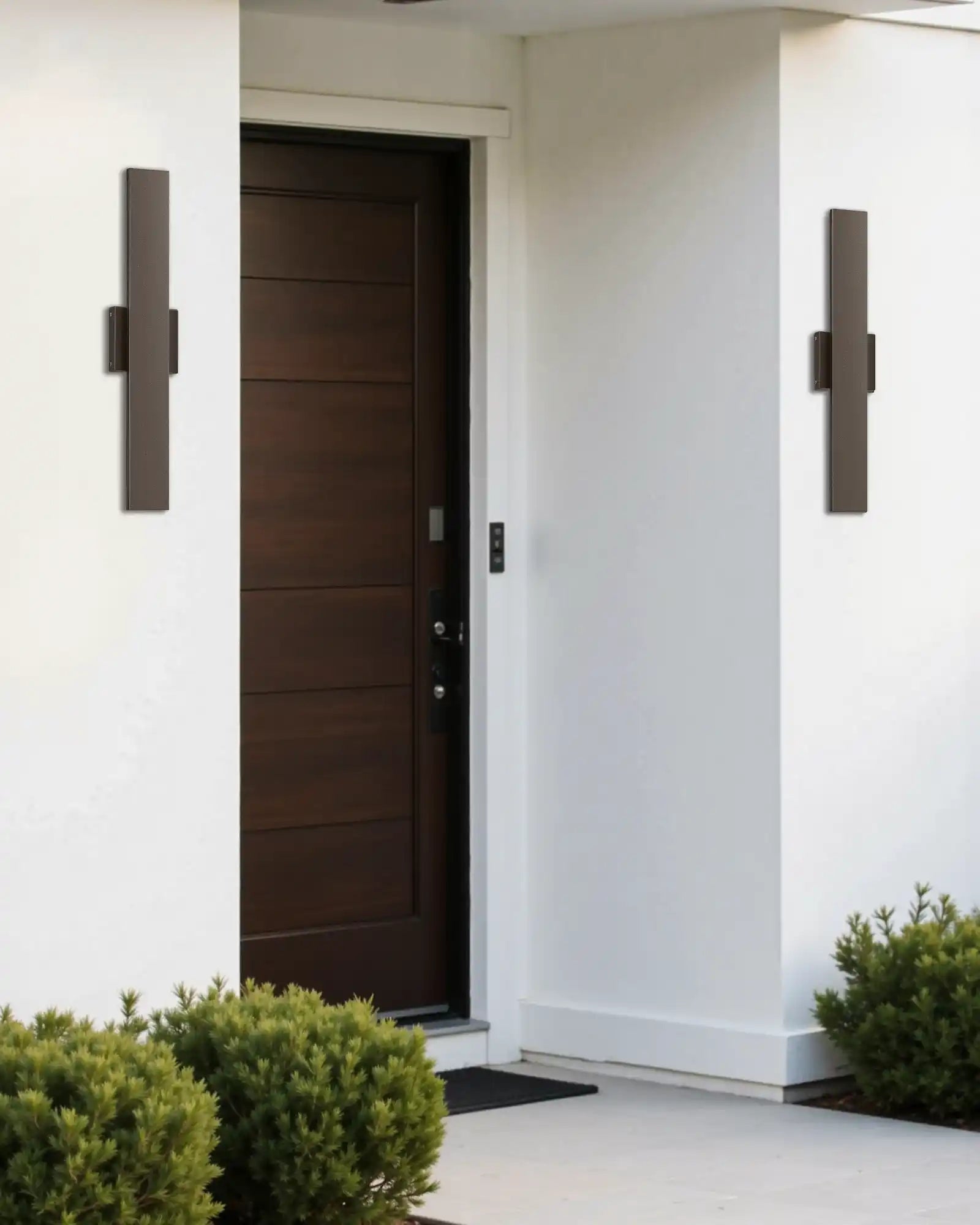 Modern front door with wall-mounted lights and a white wall background