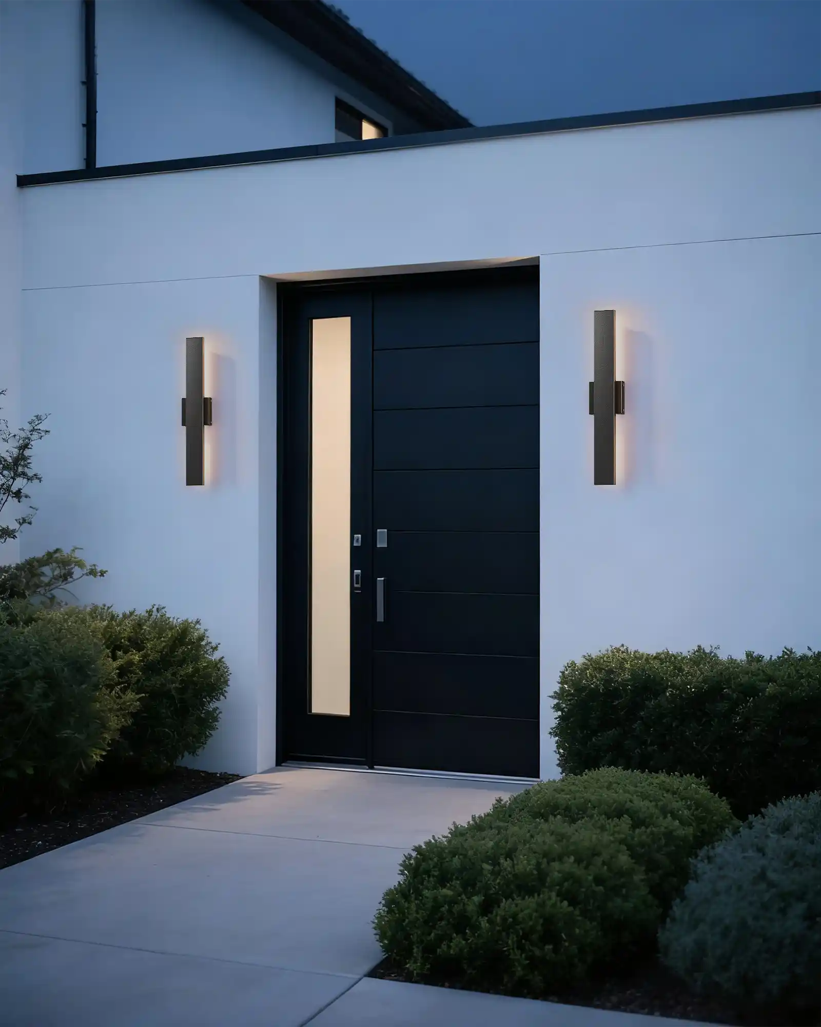 Modern black door with wall lights on a white building exterior