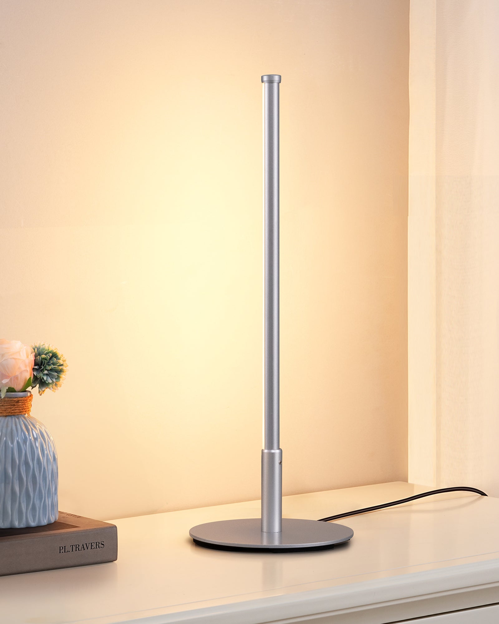 Modern LED desk lamp on a desk with a warm glow