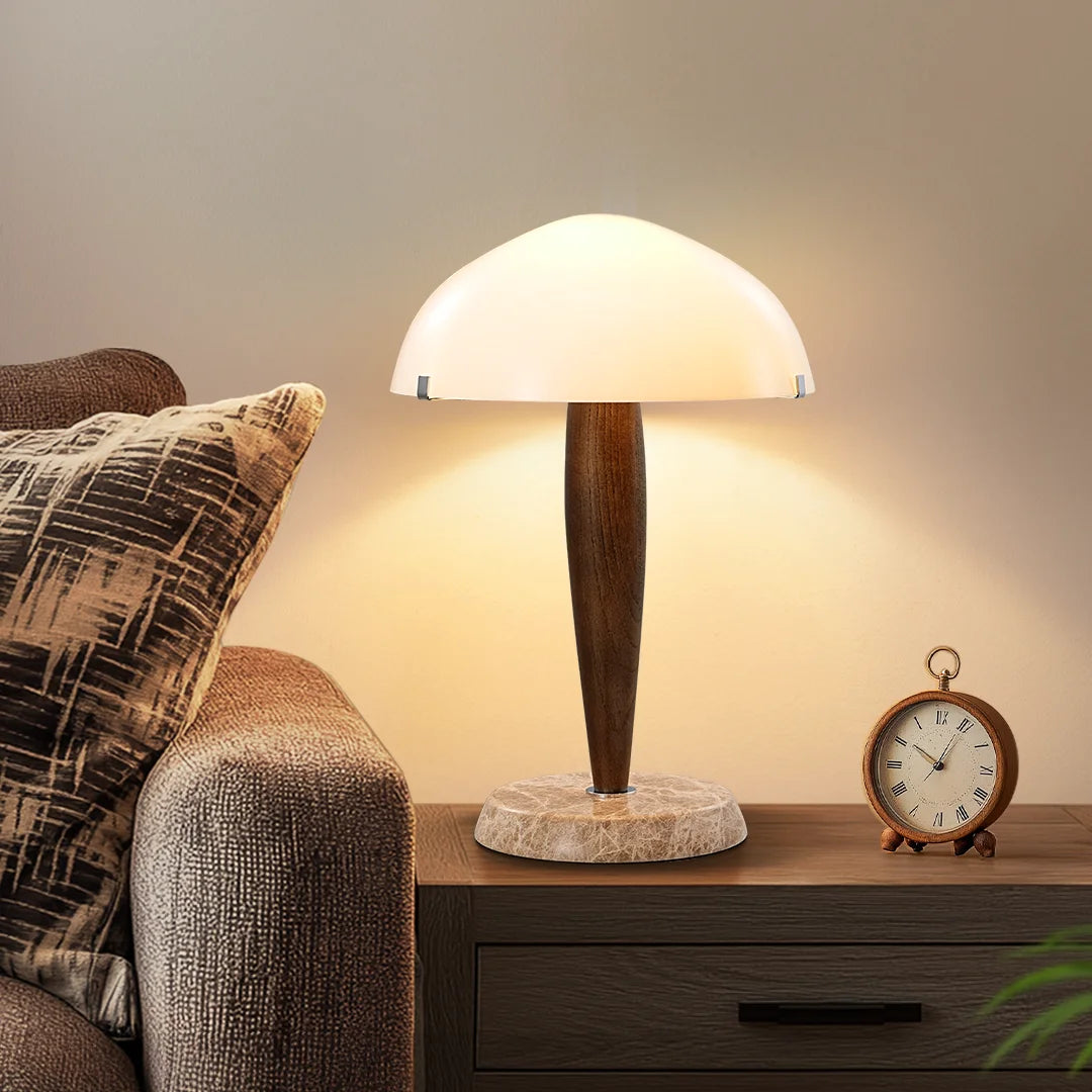 Table lamp on a nightstand next to a sofa with pillows