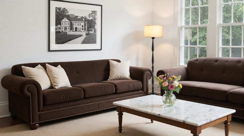 Living room with brown sofas, a marble coffee table, and decorative elements.