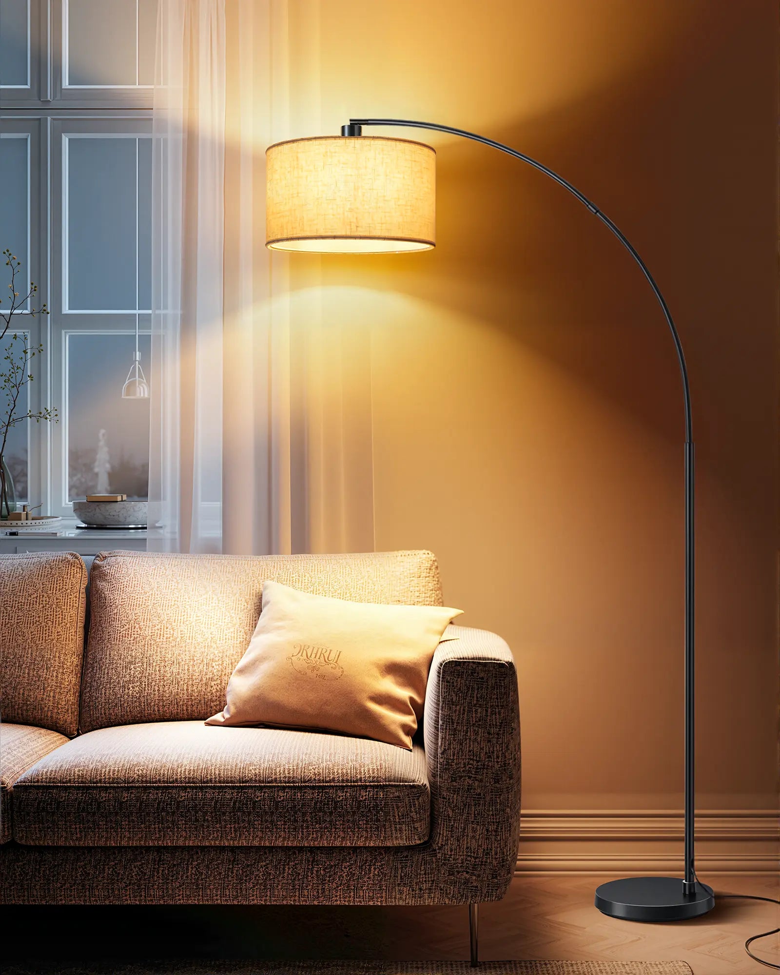 Floor lamp casting a warm glow over a sofa in a living room.