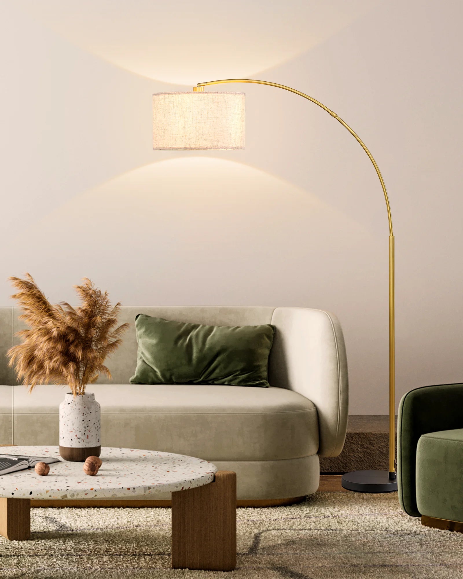 Modern living room with a beige sofa, gold floor lamp, and decorative items.