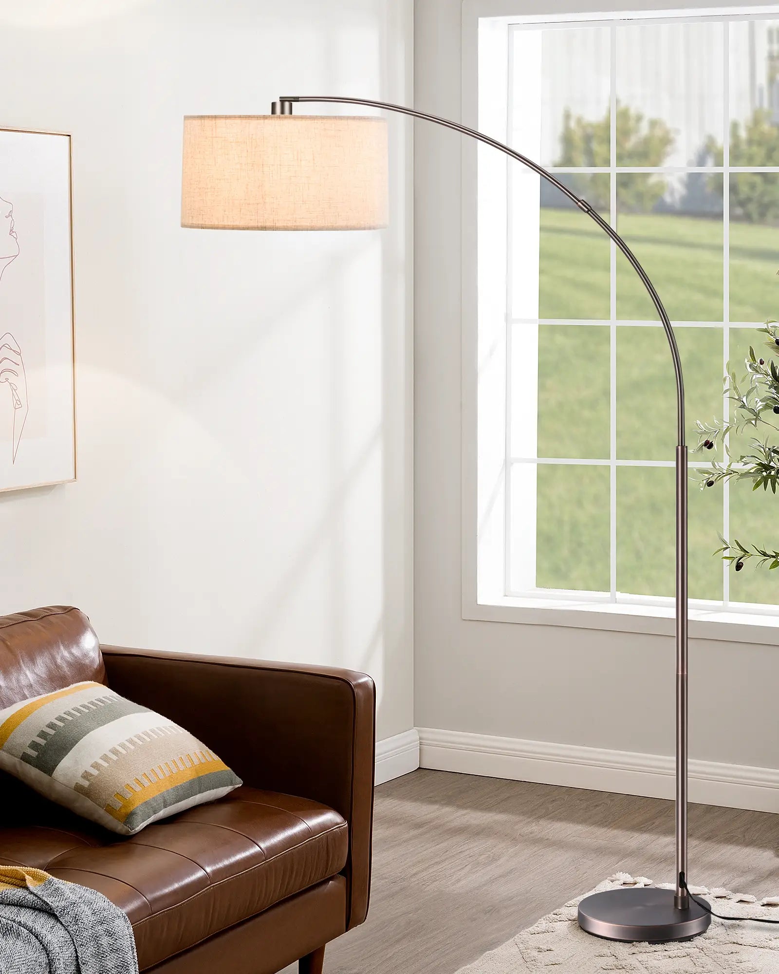 Mid-Century Modern Arc Floor Lamp lamp in a living room with a brown sofa and window in the background