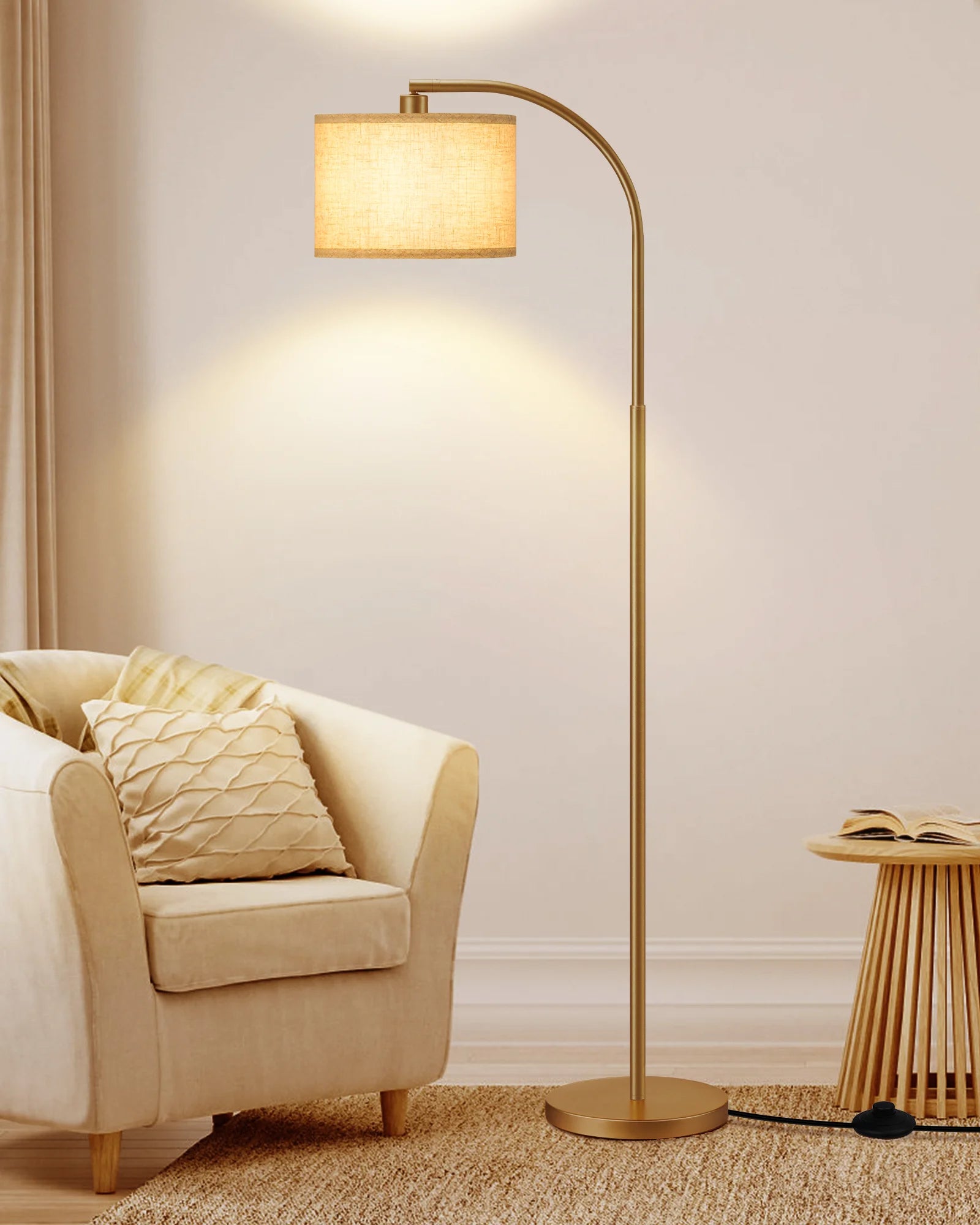 Gold floor lamp in a living room setting with a beige armchair and side table.
