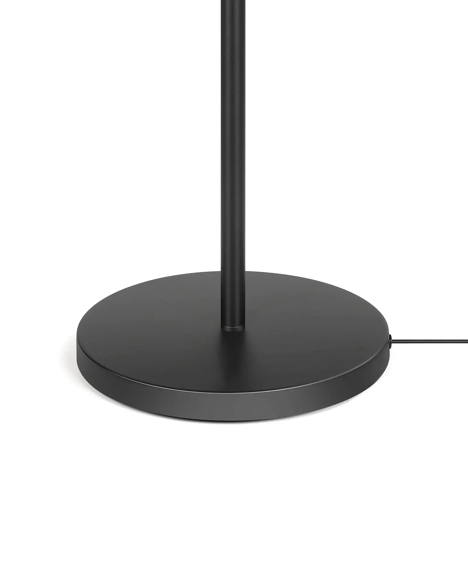 Black floor lamp with round base on a white background