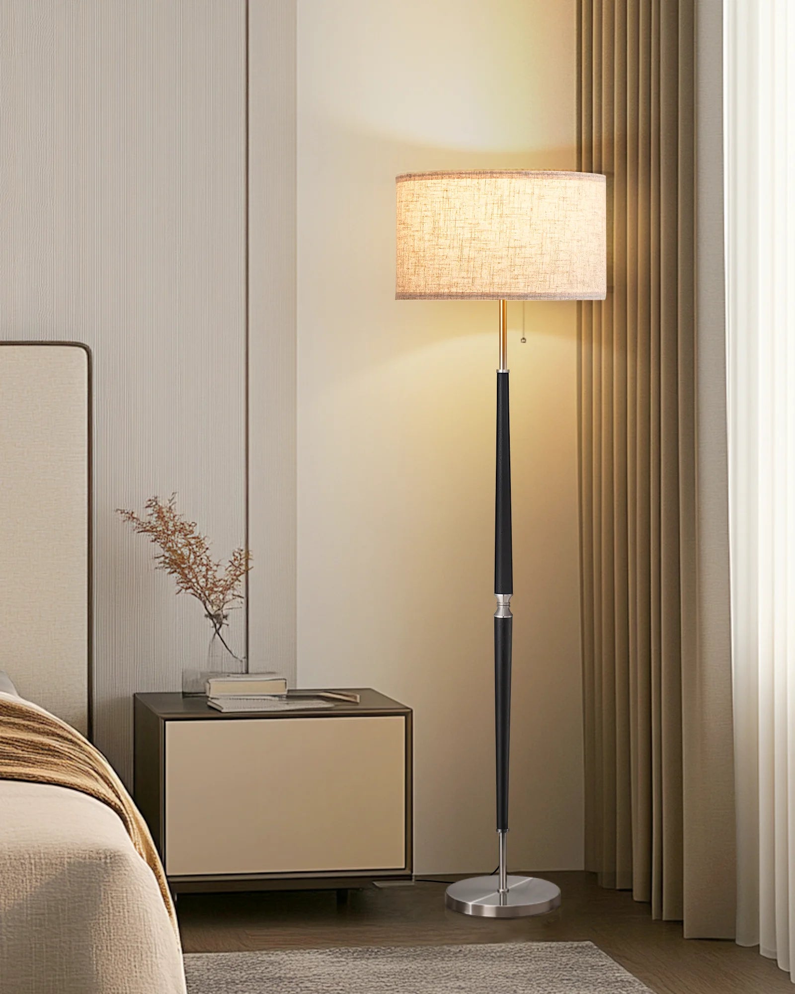 Modern floor lamp in a bedroom setting with a side table and decorative plant.