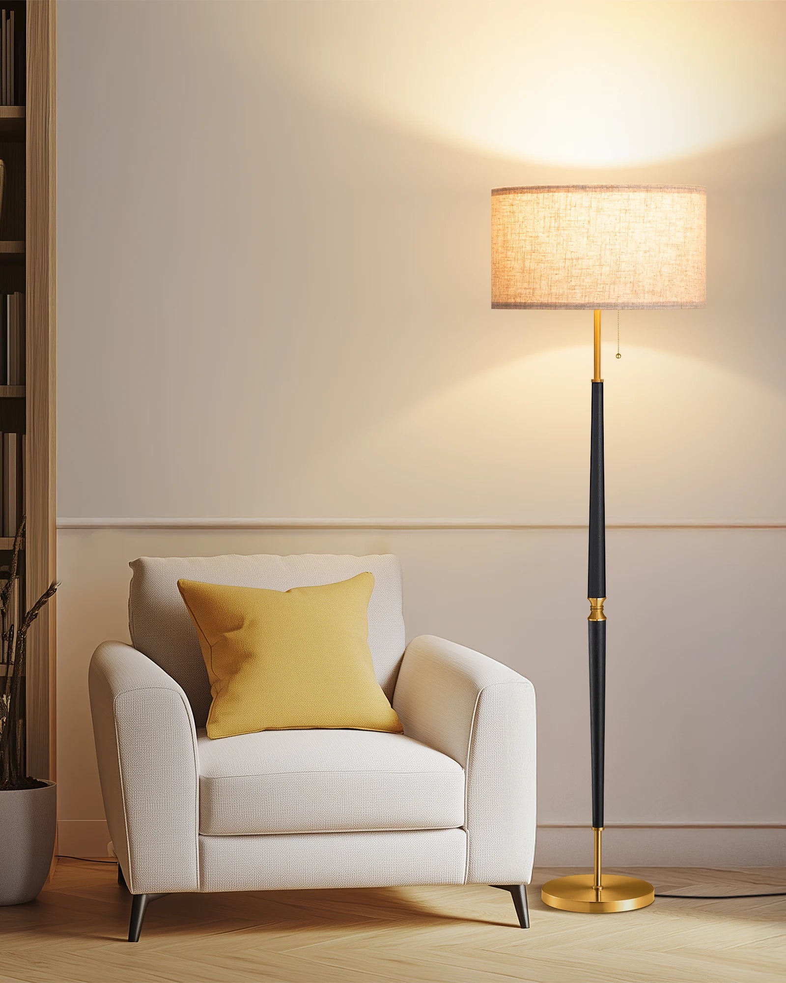 White armchair with a yellow pillow next to a standing lamp in a room.