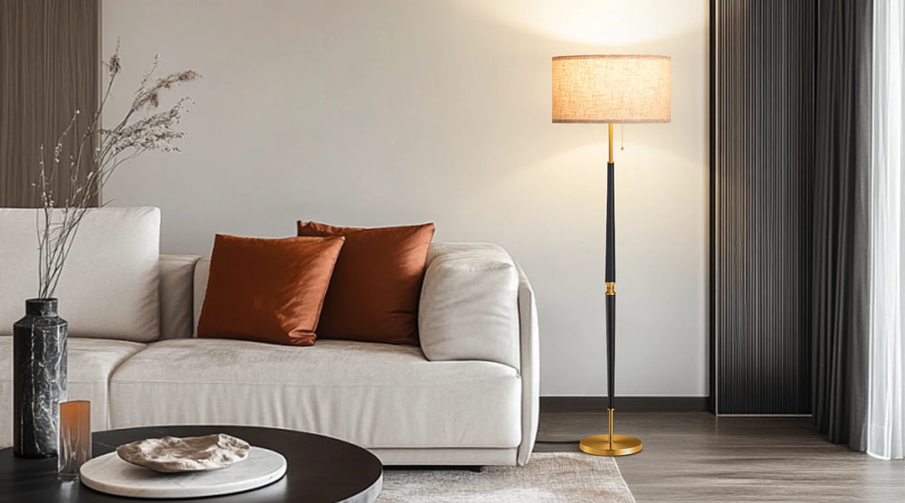 Modern living room with a beige sofa, brown cushions, and a floor lamp.