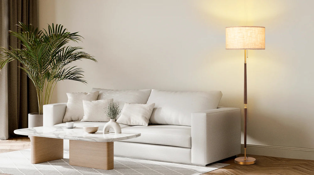 Modern living room with a white sofa, coffee table, and floor lamp.