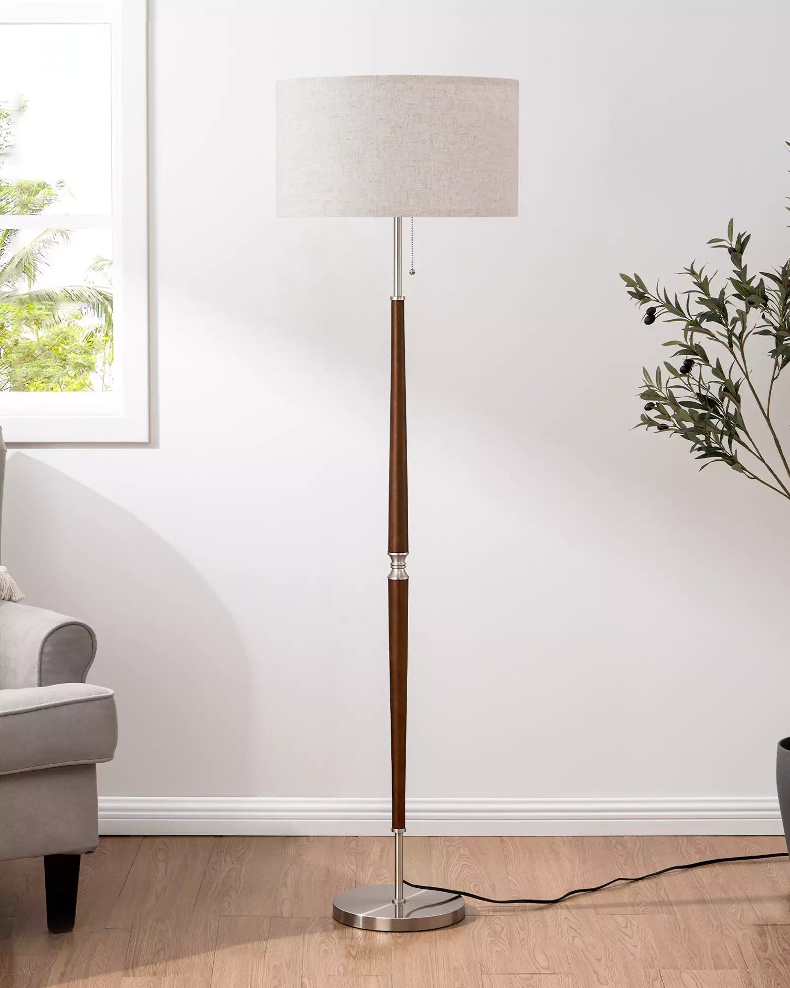 Classic Solid Wood Floor Lamp with a white shade in a room with a window and plant