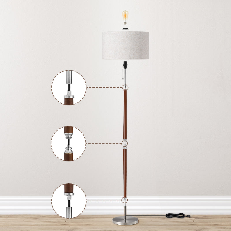 Floor lamp with a wooden base and gray shade on a light gray background