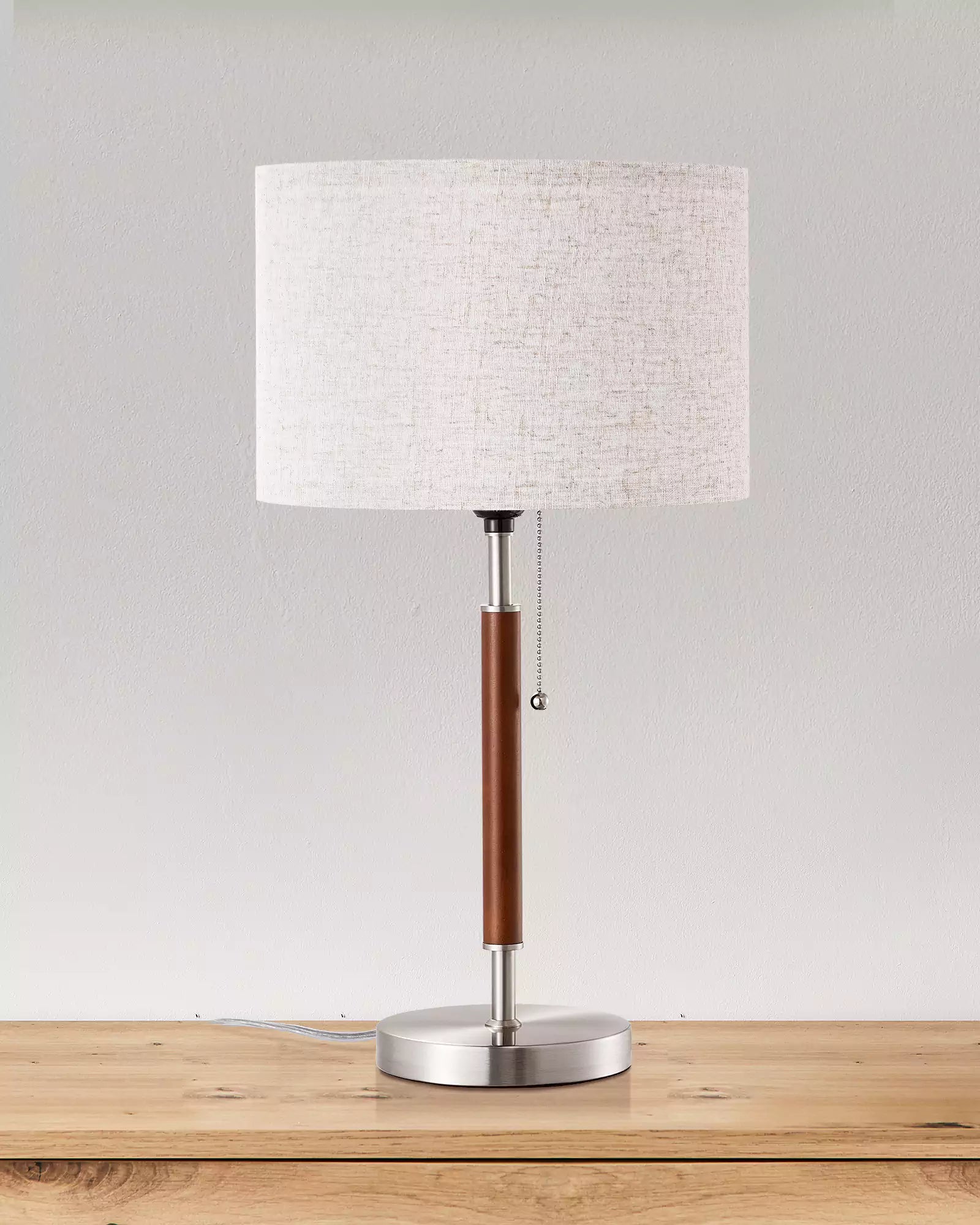 Classic Solid Wood Table Lamp with a white shade, brown base, and silver stem on a wooden surface.