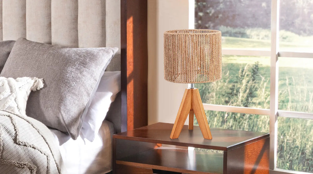 Bedroom scene with a bed, nightstand, and lamp near a window.