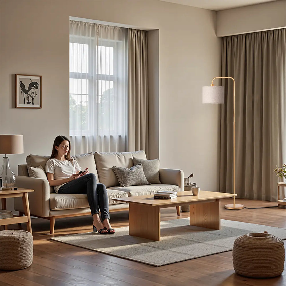 Woman sitting on a beige sofa in a modern living room with wooden coffee table and a Modern Arc Floor Lamp 