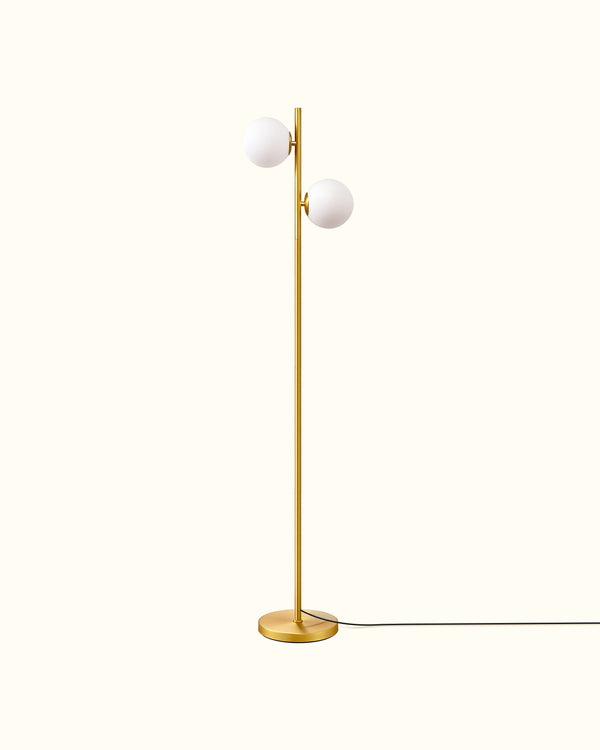 Gold floor lamp with two white spherical lights on a white background