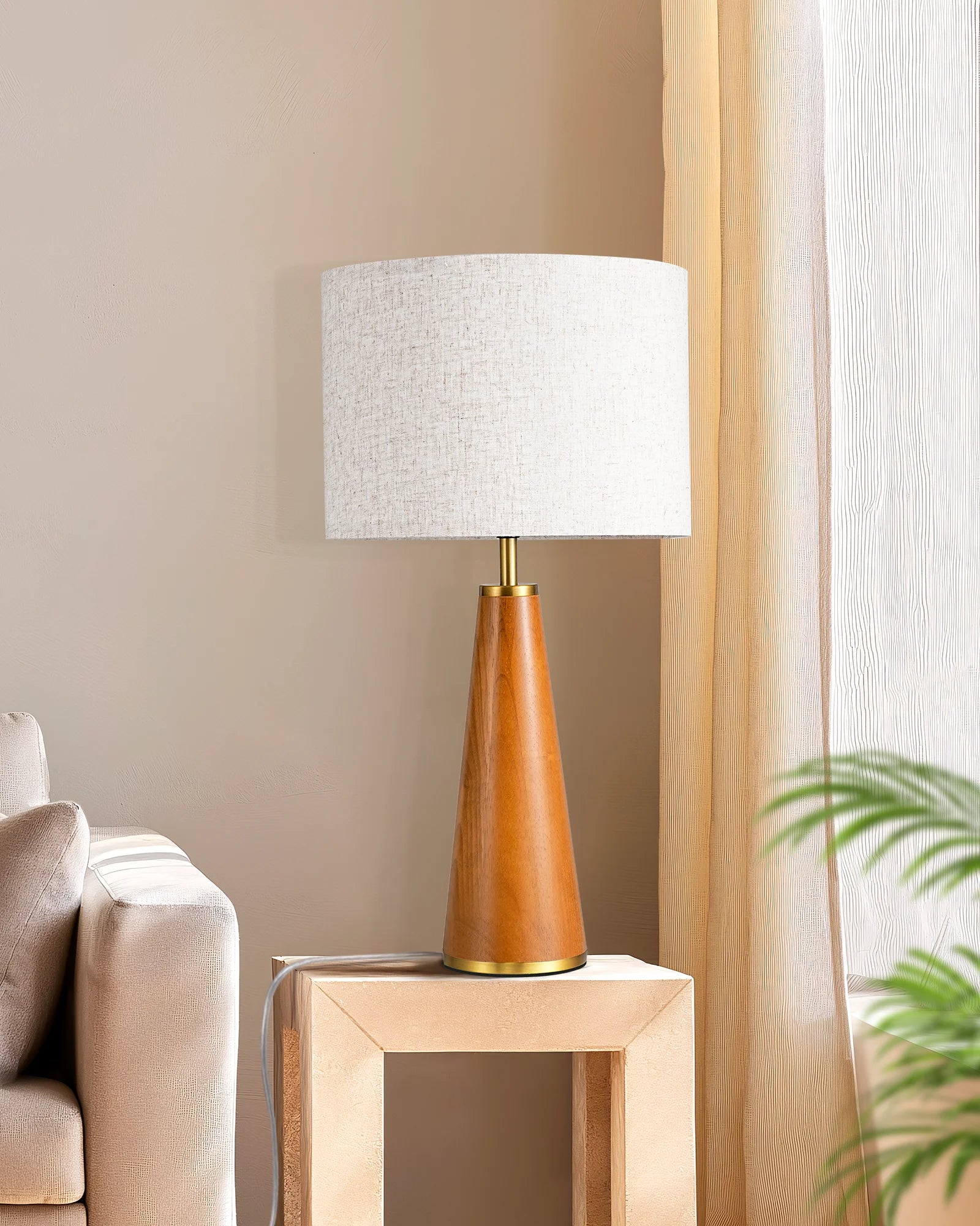 Solid Wood Table Lamp with wooden base and white shade on a side table next to a sofa.