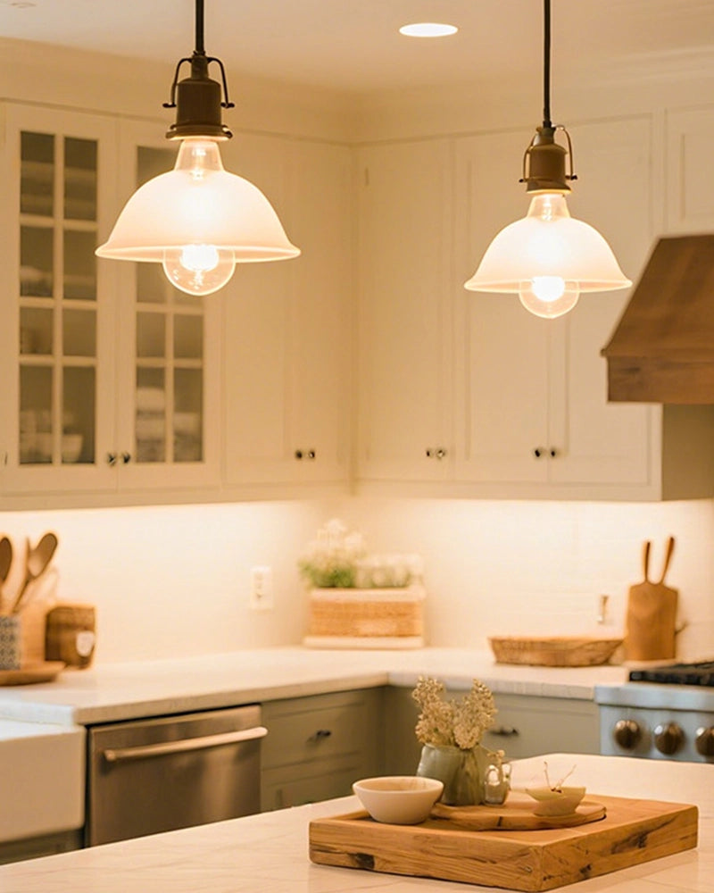 The warm glow of the chandelier shines in the kitchen