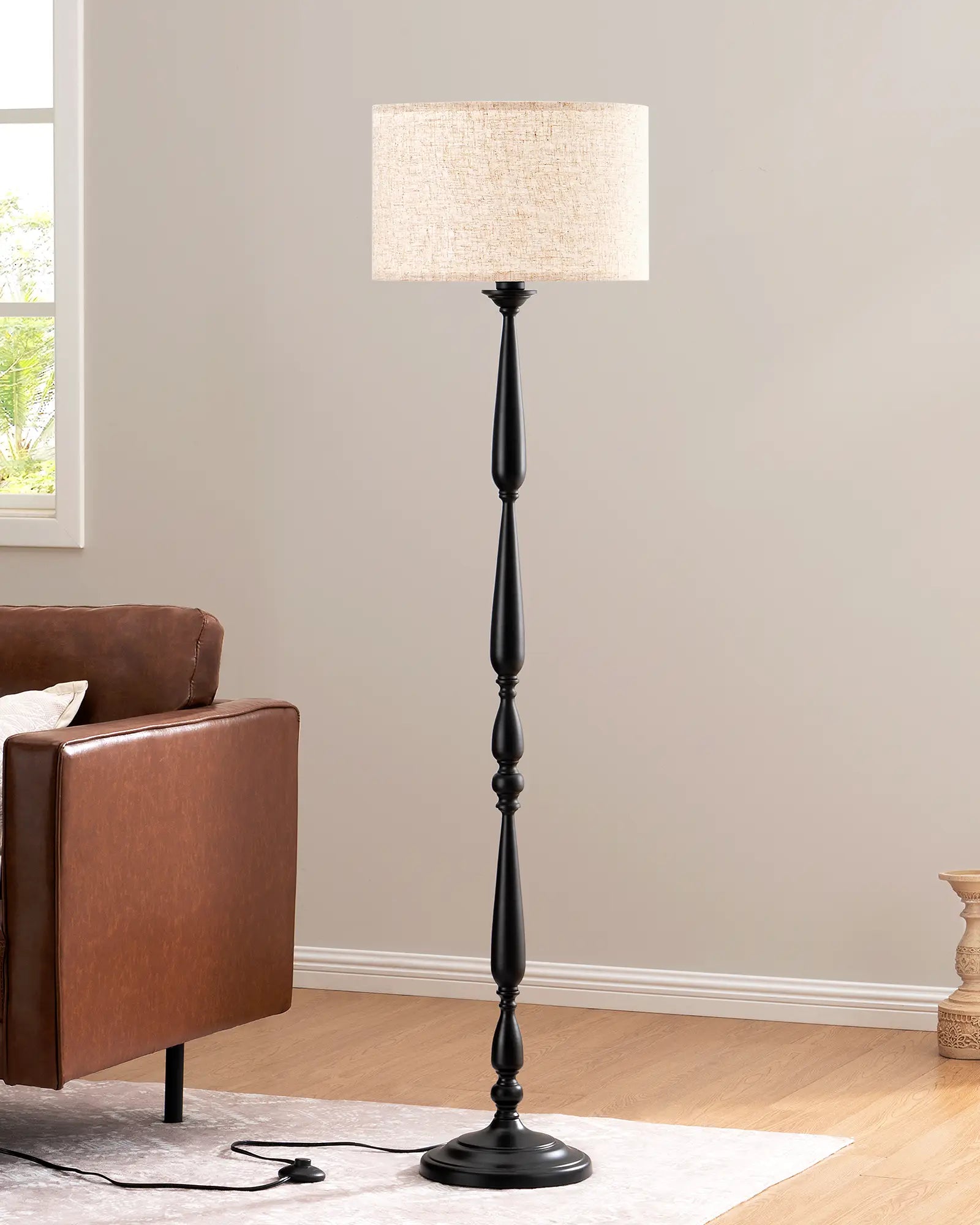 Traditional Floor Lamp with a beige shade in a room with a brown armchair and a window.