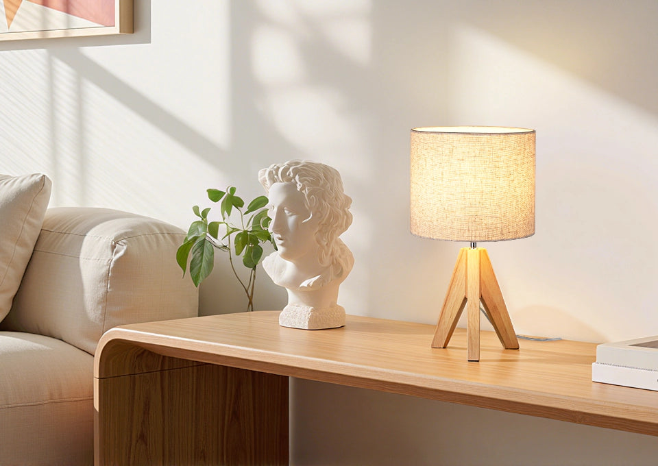Decorative lamp and bust on a wooden table in a living room setting